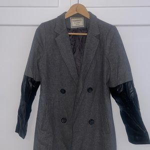 Grey trench coat with black leather half sleeves